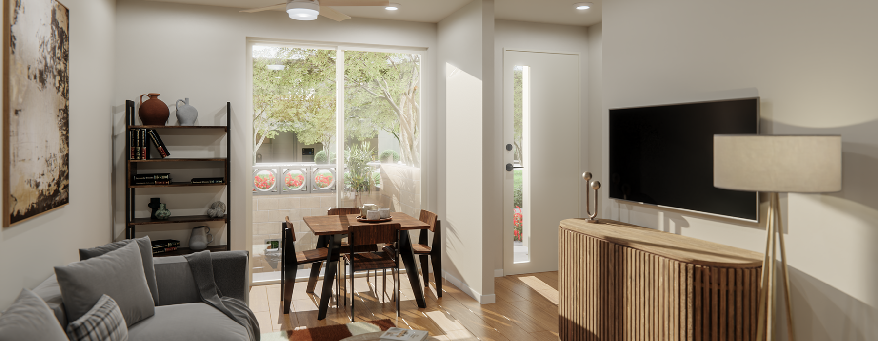 Interior view of a Sonoran Row townhome featuring an open living and dining area with natural light, modern furnishings, and direct access to a private front entry.