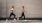 two women running on a street