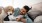 a person lying on a bed with a dog