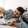 a person lying on a bed with a dog