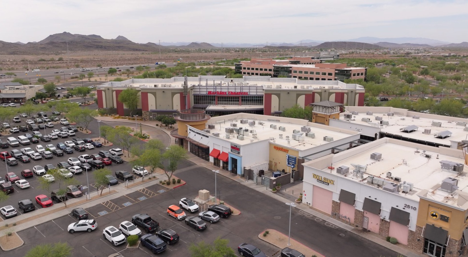 aerial view of buildings trees and parking lot