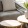 a couch with a table and a vase with plants on it