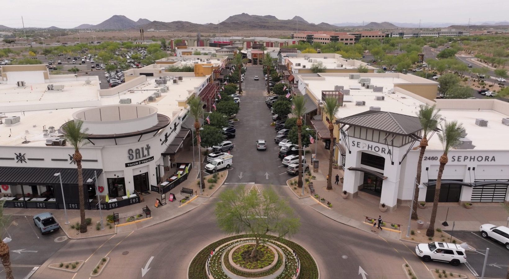 aerial view of road between shopping center