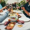 A group of people eating at a table outside