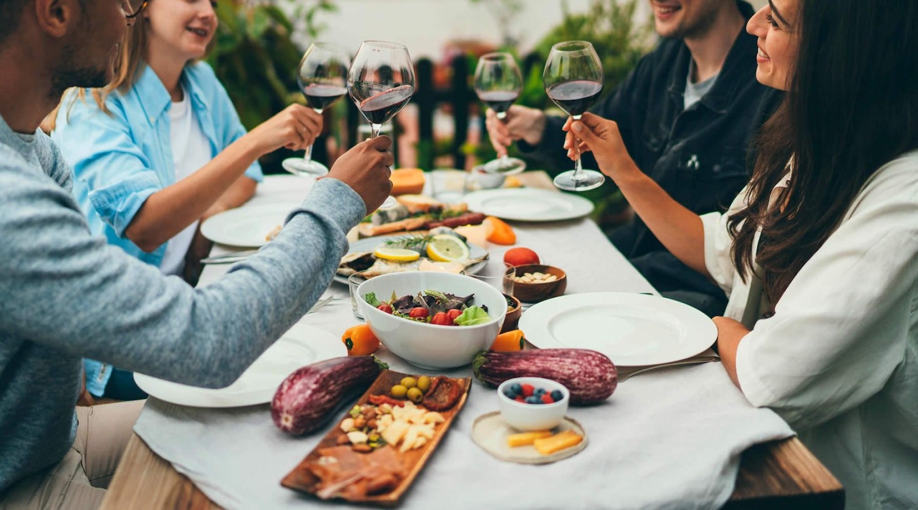 A group of people eating at a table outside